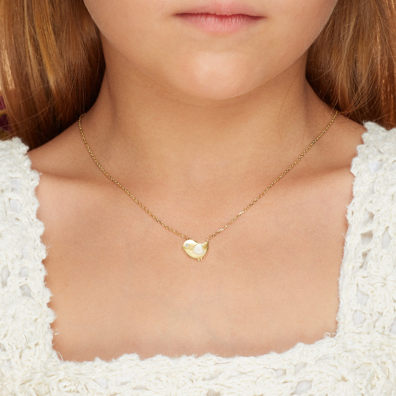 Our 14 karat gold necklace for girls. This adorable bird necklace features pearl enamel hand-painting and a diamond eye that will make her sparkle. Kids jewelry