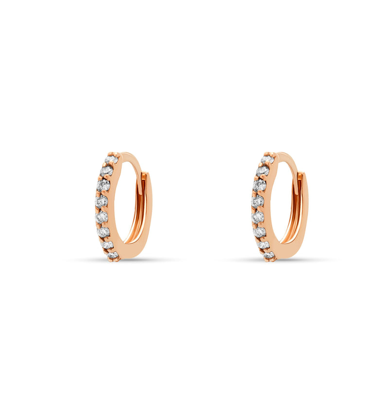 rosegold. Our 14 karat gold huggie earrings feature handset diamond pave stones and are the ultimate essential for an every day sophisticated look.