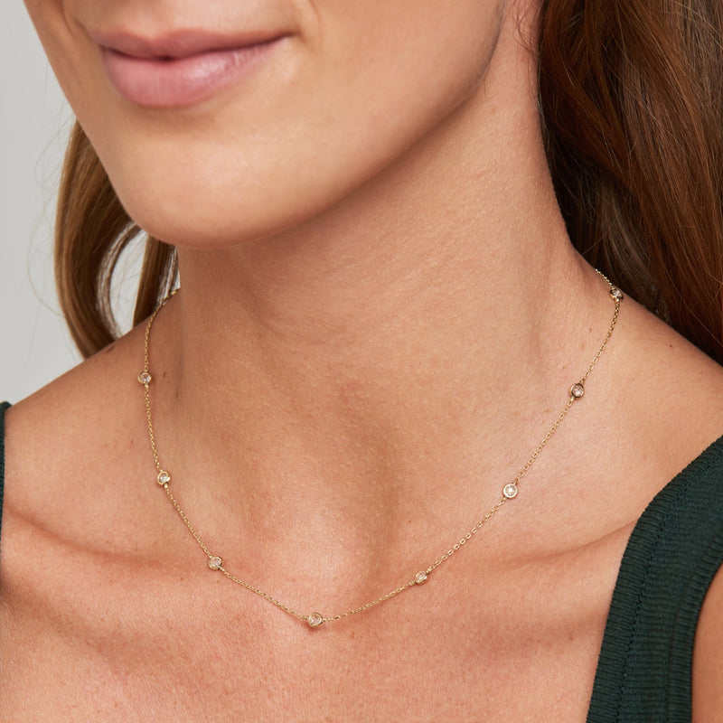 This delicate 14 karat gold necklace is handmade and features sparkling bezel - set stones.  Wear it during the day and keep it on for your evening date. We promise, once you will put this gold necklace on, you will never want to take it off again! This simple diamond necklace is also available as a rose gold necklace.