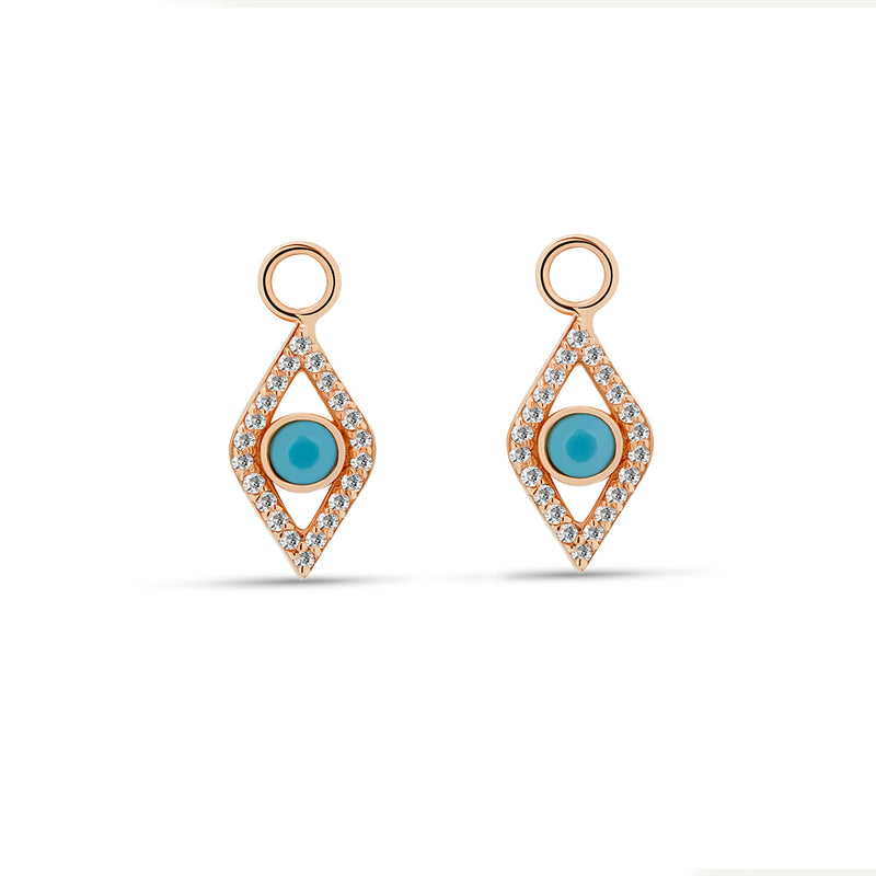Our dazzling 14 karat gold charms for hoops feature the turquoise evil eye embodied in diamonds. Wear these charms on our Diamond Huggies or Essential Hoops for an extra dose of sparkle. Also available in  rose gold.