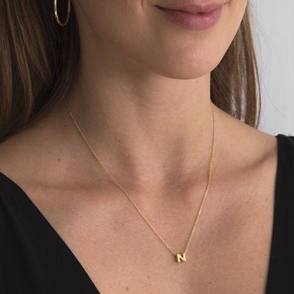 A 18 karat gold vermeil necklace with your initial letter "N". This diamond letter necklace is a special jewelry necklace that can be worn day and night. A genuine diamond stone in the corner of the letter makes this gold diamond necklace a luxury and ideal gift for yourself, your best friend or loved one.