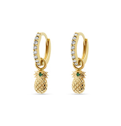 Our diamond gold huggie earrings in 14 karat gold feature pineapple charms with a handset green sapphire stone. A beautiful diamond earring that feels light and comfortable on the ear. 