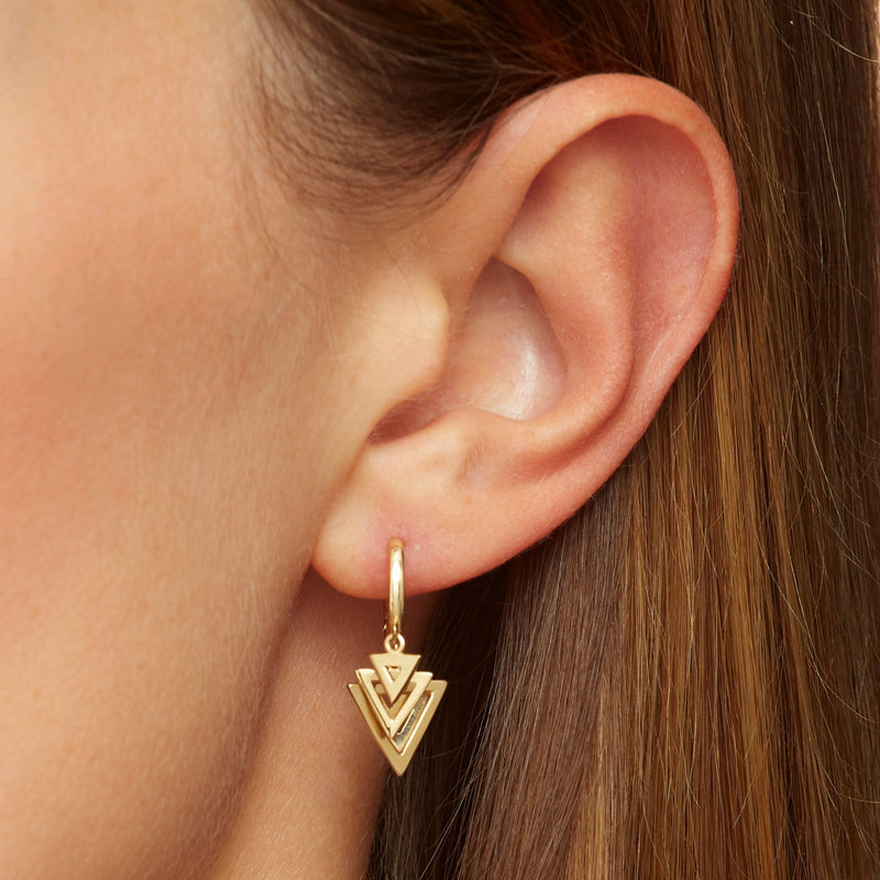 Our 14 karat gold bestseller earrings featuring triangle charms.